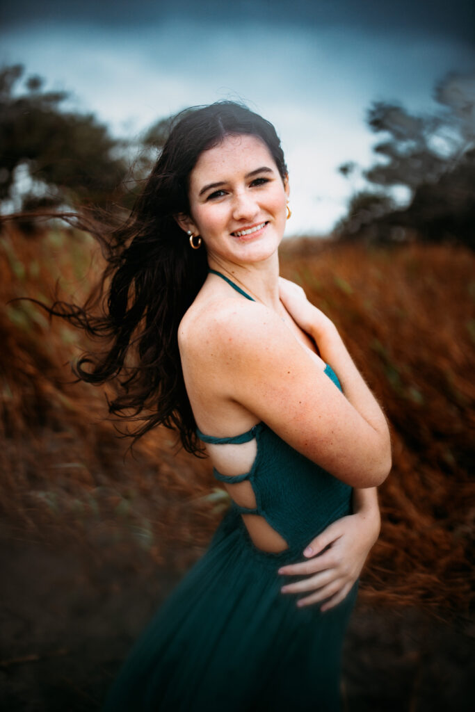 Senior photo at Folly Beach SC near Morris Island Light House by Neha Kotecha Photoraphy.