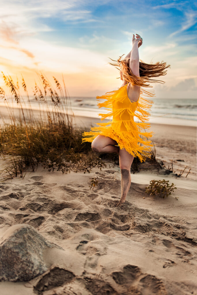 Senior photo at Folly Beach SC near Morris Island Light House by Neha Kotecha Photoraphy.